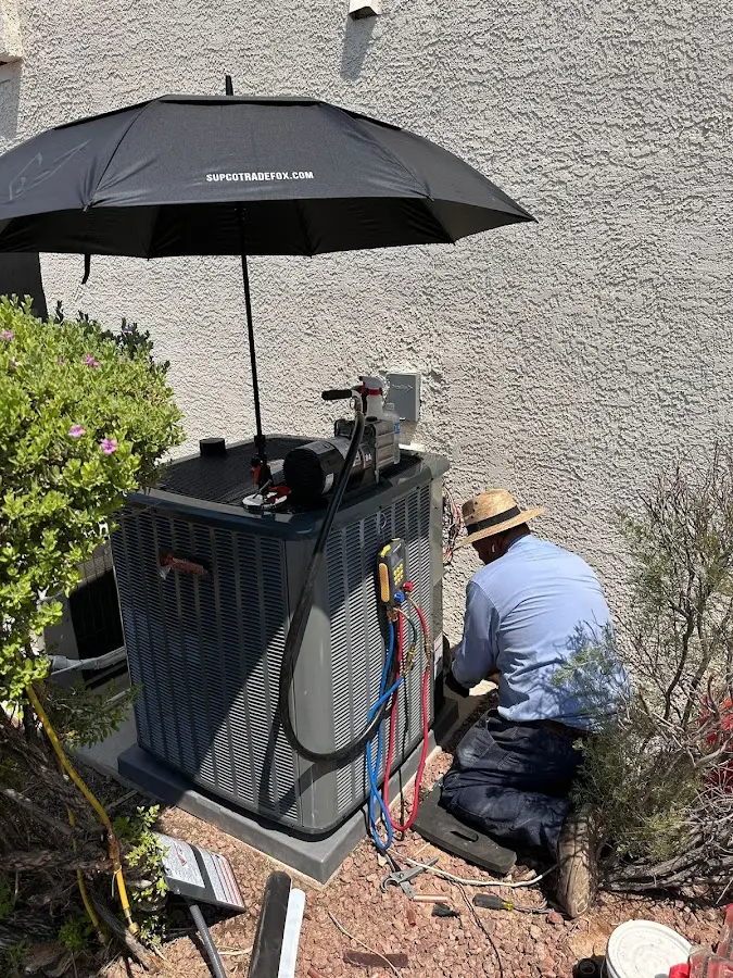 HVAC technician performing outdoor AC maintenance in Dunedin